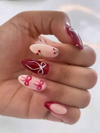 A festive design with hand-painted red bows and holly berries on a sheer pink base.