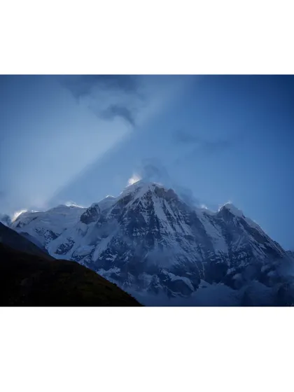 Sun rays create a dramatic effect over the peak of Annapurna, a moment of pure mountain magic captured during our trek.