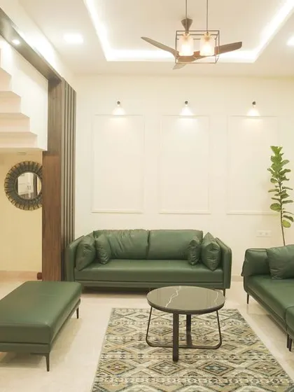 A slightly different angle of the villa living room, highlighting the comfortable seating arrangement and the clean, modern aesthetic.