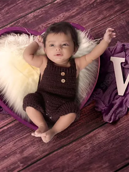 A lovely portrait of a two-month-old baby in a heart-shaped prop. I use simple wooden letters to add words like 'LOVE' to the setup.