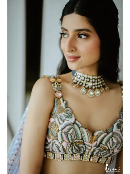 Another beautiful close-up. Her skin looks luminous, and the makeup enhances her features without being heavy.