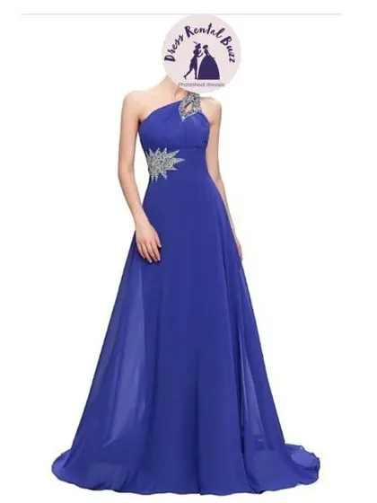 A royal blue one shoulder gown with a flowing chiffon skirt and silver embellishments on the strap.