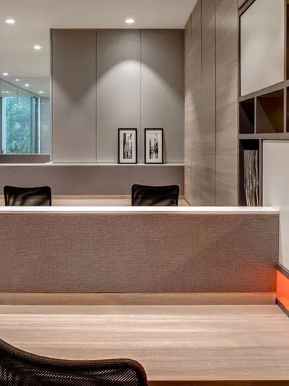 A view of the Pharmaserve office project. The design uses low partitions to maintain an open feel, while the pops of orange in the shelving create a vibrant and energetic workspace.