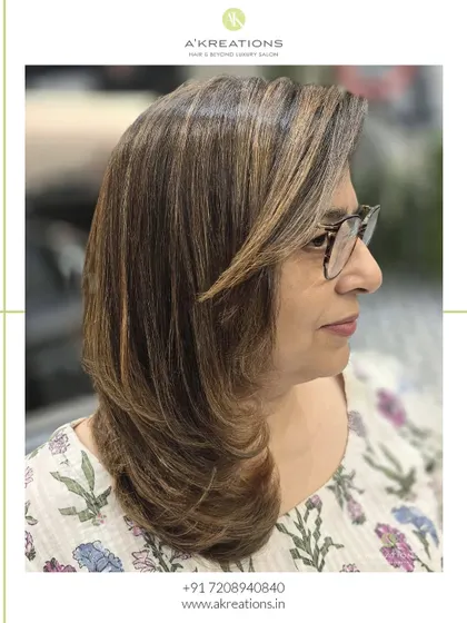A profile view of our brunette with highlights, showing how the color and cut work together to frame the face.