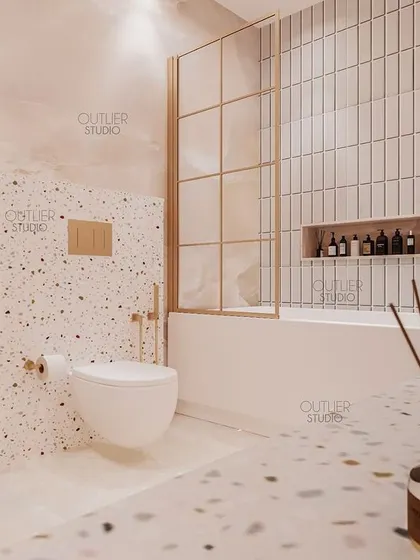 A closer look at the kids' bathroom, showing the use of terrazzo-style tiles and a simple, clean bathtub area with a gold-framed glass partition, blending playfulness with modern design.
