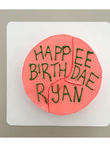 A top-down view of the iconic, lovingly misspelled Harry Potter birthday cake. It's the perfect quirky and heartfelt treat for any fan of the wizarding world.