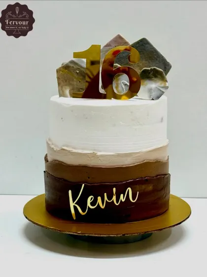 A modern chocolate cake with a three-tone ombre effect. This cake is decorated with isomalt shards and a custom name topper for a stylish finish.