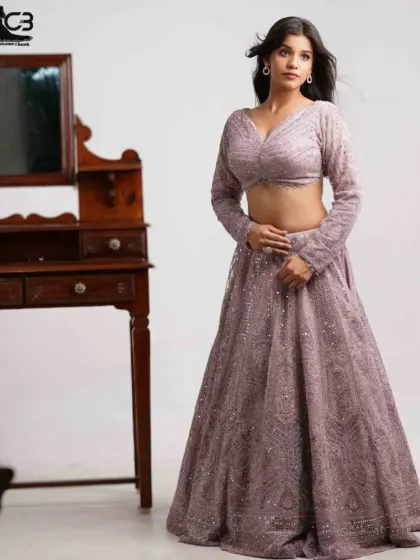 A stylish shot of a model posing in a lavender sequin lehenga, perfect for a modern bridal or party look.