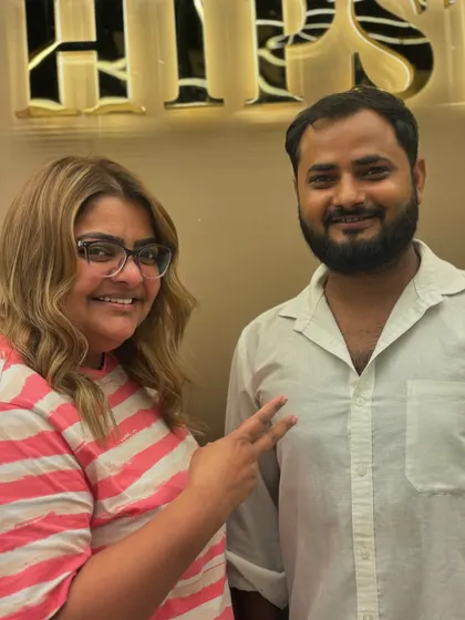 A happy client posing with her stylist after a beautiful hair color transformation. The blonde tones bring a new dimension and shine.