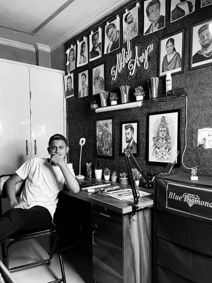 A black and white photo of me in my art studio. This is my creative space, surrounded by my sketches, tools, and inspiration.