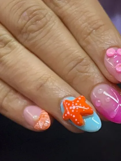 Another view of the holiday beach nails, with a bright orange 3D starfish and other sea-themed accents.