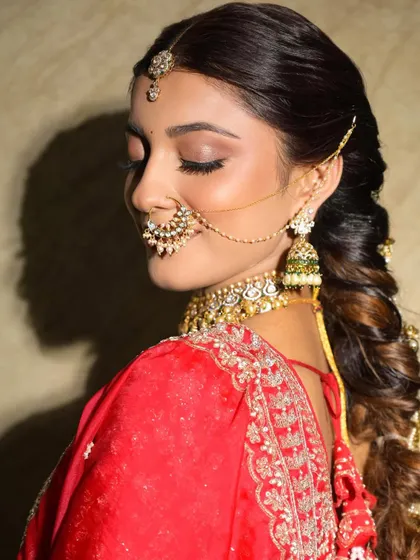 A close-up on the soft brown smokey eye and intricate nath. This look combines traditional elements with a modern soft glam makeup style.