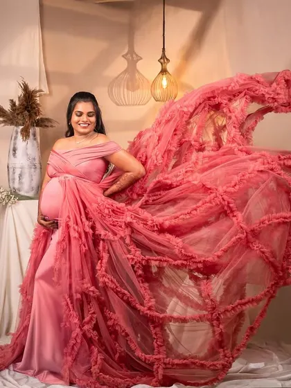 The flowing pink fabric creates a dynamic and beautiful effect in this studio shot, adding a sense of movement and grace.