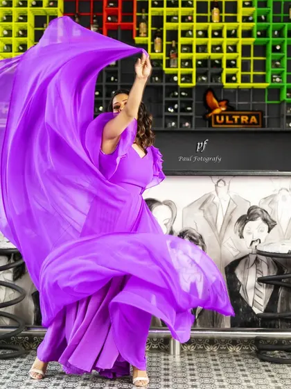 The purple gown in motion, showing how the lightweight fabric creates a beautiful, flowing effect.