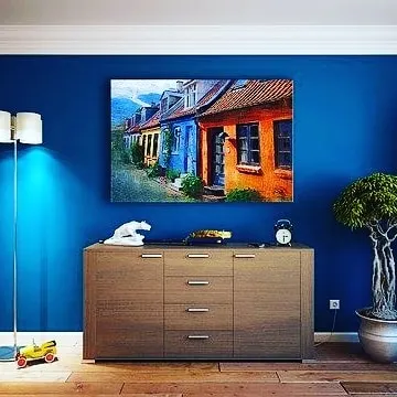 A living room with a bold, solid blue accent wall. This shows how a single painted wall can dramatically change the mood and style of an entire room.