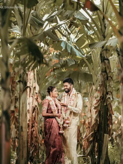 A unique portrait of the couple standing in a banana grove, using the natural surroundings to create a stunning frame.