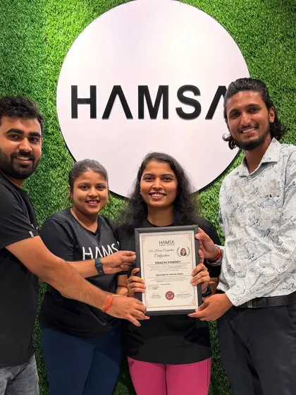 A student receives her TTC certificate. This moment represents not just the completion of a course, but the beginning of a new journey as a yoga teacher.