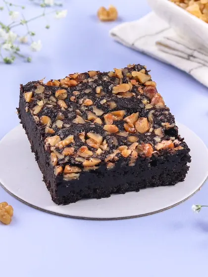 A classic Walnut Brownie, done right. My brownies are rich, fudgy, and made with dark chocolate, topped with a generous layer of crunchy walnuts for the perfect texture.