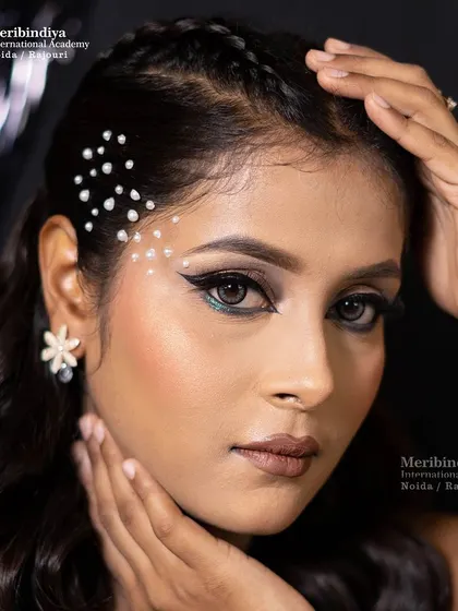 A creative and modern party hairstyle featuring pearls placed along the hairline and a braided front section.