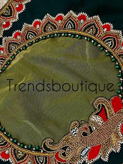 A detailed close-up of the sheer back panel. The border is heavily worked with zardosi and beads, and a peacock motif adds a touch of grace.