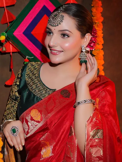 A close-up on the traditional jhumkas and maang tikka that complete this festive look.