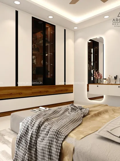 This bedroom features a modern wardrobe with a built-in dressing table and an illuminated mirror. The combination of white and wood creates a clean and warm aesthetic.