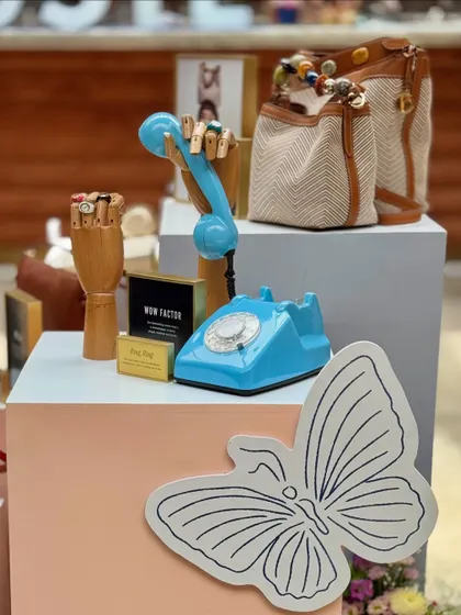We love incorporating quirky and thematic props into our designs. This display for Fossil featured a vintage-style telephone and wooden mannequin hands to creatively showcase the brand's bags and accessories.