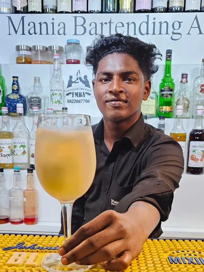 A student at our Goa branch with a large, refreshing mocktail, proving our commitment to quality across all beverage types.