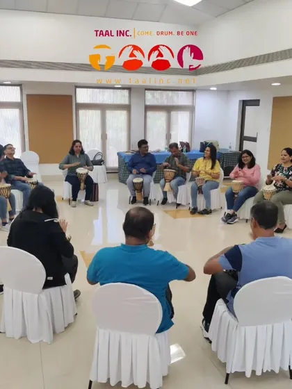 A group of executives deep in a leadership training drum circle. The focus isn't on playing perfectly, but on listening to each other and contributing to the group's rhythm, a direct parallel to effective team leadership.