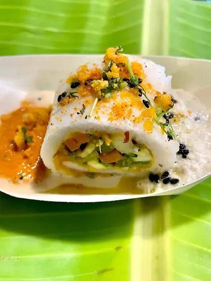 Here is a closer look at my Sushi Idli, where traditional idli batter is transformed into a delicate roll. It's filled with crunchy vegetables and served with both coconut and spicy tomato chutney for a complete flavor experience.