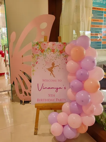 A welcome sign for Vinamya's 5th birthday party, setting a graceful tone with its ballerina and butterfly design.