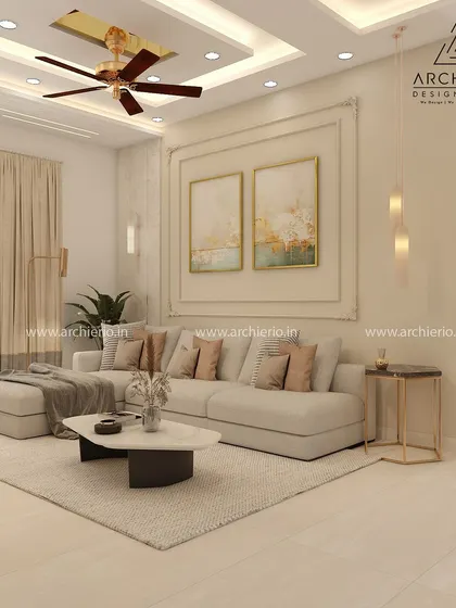 This living room in a Prestige Glenwood Villa showcases a comfortable L-shaped sofa and elegant wall paintings. The design is clean, modern, and filled with natural light.