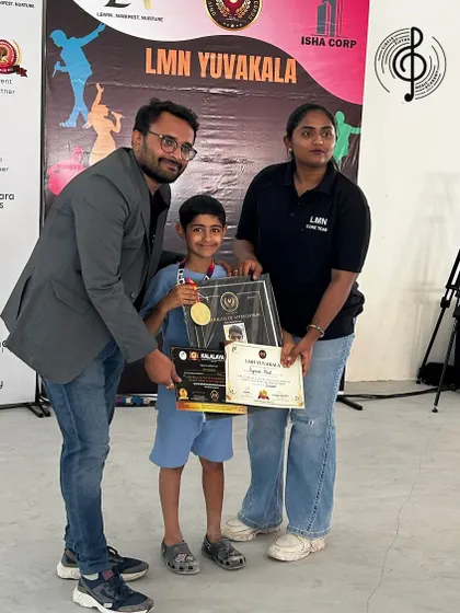 Reyansh proudly holds his awards after his showstopping drum performance. We love celebrating our students' success on the big stage.