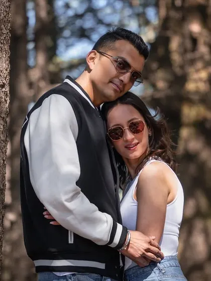 A quiet, intimate hug in the forest. This pose shows their closeness and comfort with each other.