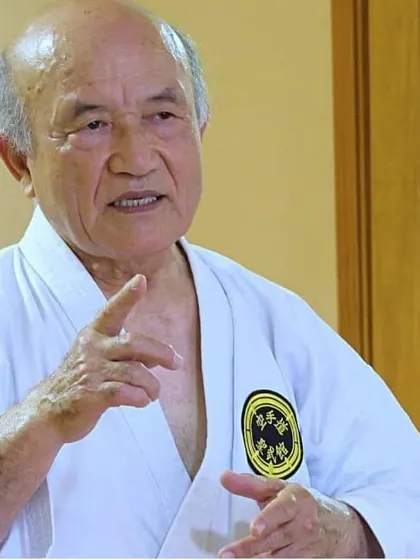 Grand Master Zenpo Shimabukuro, 10th Dan Hanshi, instructing students. His ability to explain complex principles is a hallmark of a true master, and his teachings form the curriculum of my dojo.