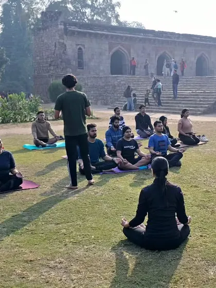 Leading a community yoga session. As Mahatma Gandhi said, our habits become our values, and our values become our destiny. Let's build positive habits together.