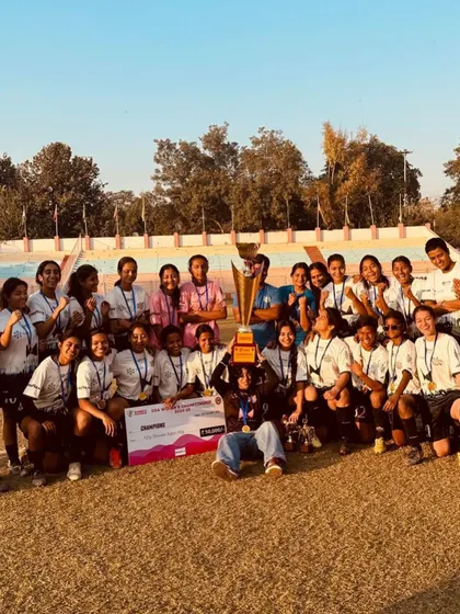 The entire team gathers around the championship trophy. This is a family, a unit that fought together and now celebrates a well-deserved victory as champions.