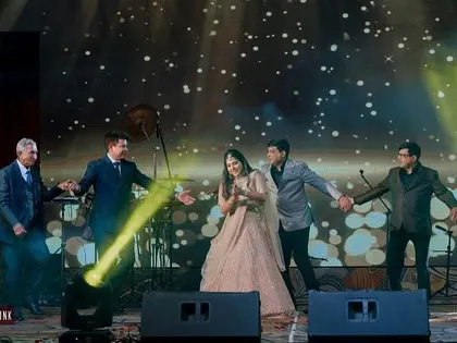 The bride enjoying a performance by her family. These moments of connection are what it's all about.