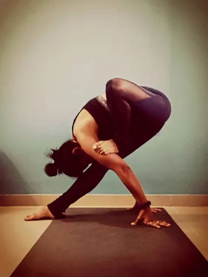 This is a challenging variation of Parsva Bakasana, or Side Crow Pose. Twisting arm balances require immense core strength, flexibility in the spine, and a deep sense of focus to maintain stability.