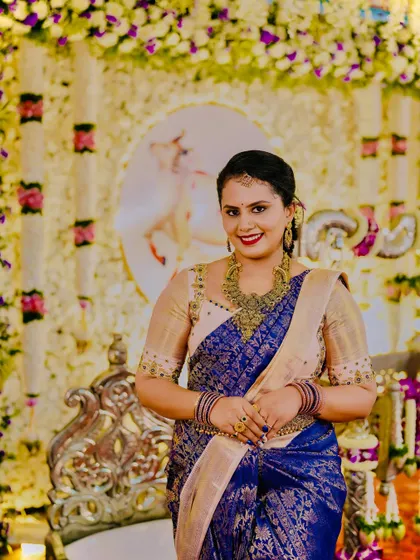 A beautiful smile from a happy client. The subtle embroidery on her blouse adds a touch of class without overpowering the saree.