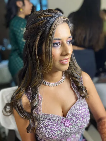 A profile shot highlighting the hairstyle and the way the makeup catches the light.