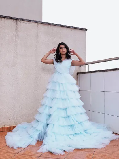 This image showcases the grand scale of the gown. The makeup remains a key part of the look, providing a polished and complete feel to this high-fashion concept.