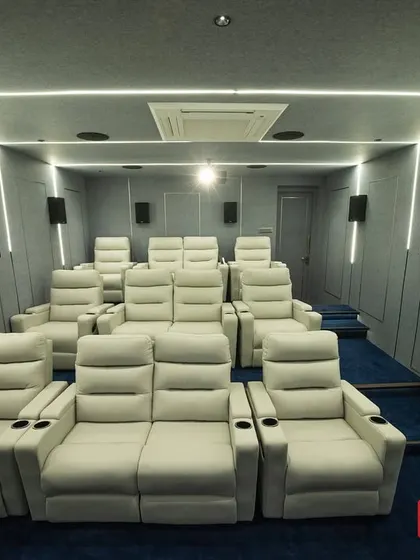 A full view of the multi-row recliner setup in this modern Madurai theater. Each seat is a premium, motorized recliner with its own cup holder, providing ultimate comfort for long movie sessions.