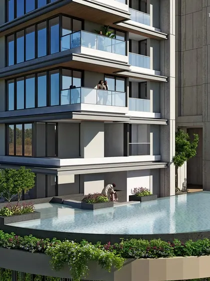 The podium-level pool at our luxury residential project in Khar. Surrounded by lush greenery, this amenity space offers a tranquil escape with views of the floors above, seamlessly blending recreation with the building's architecture.