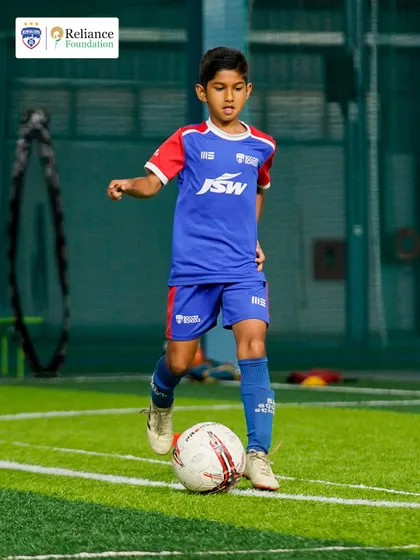 With eyes on the ball, a young player prepares to make his next move. Our training emphasizes awareness and quick thinking.