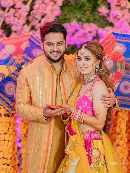 A happy portrait of the couple at their colorful Mehendi ceremony.