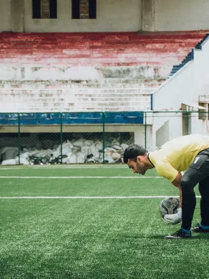 A portrait of Akash Kola, who is pursuing higher education in Manchester. His journey from a beginner in 2017 to our senior team captain is a powerful story of growth.