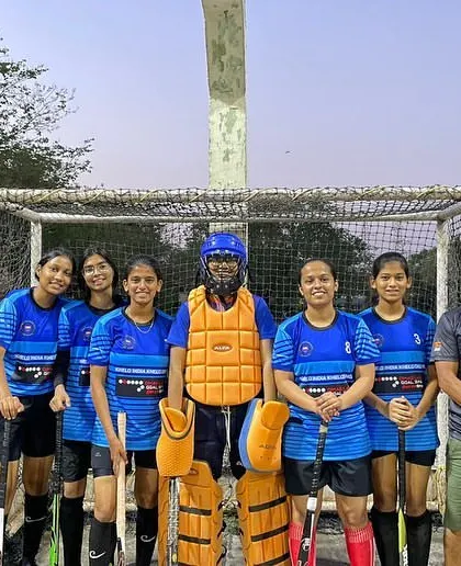 The girls' team poses with their coach after the exhibition match. These events are a great experience for our players and help promote women's hockey.