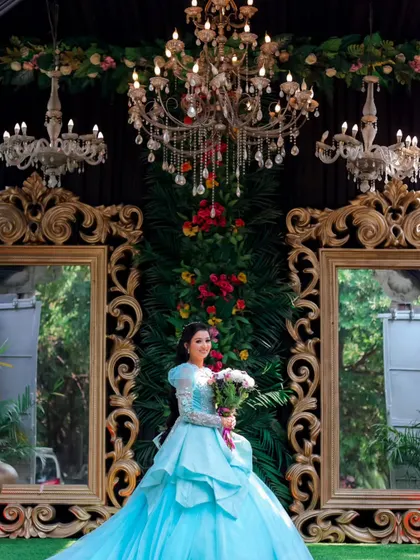 A stunning portrait of the bride-to-be, framed by grand chandeliers and mirrors. This shot highlights the luxurious decor of the engagement venue.