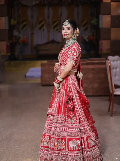 A beautiful side profile that highlights both the makeup and the intricate details of the bridal lehenga.